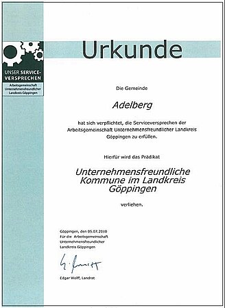 Urkunde mit dem Text "Die Gemeinde Adelberg hats ich verpflichtet, die Serviceversprechen der Arbeitsgemeinschaft Unternehmensfreundlicher Landkreis Göppingen zu erfüllen. Herfür wird das Prädikat Unternehemnsfreundliche Kommune im Landkreis Göppingen verliehen."